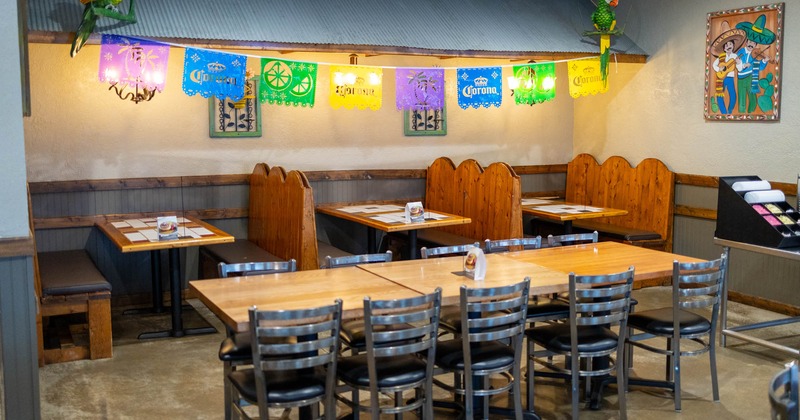 Interior, dining area, long table setup for ten, seating booths in the back