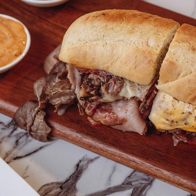 A prepared sandwich and dip.