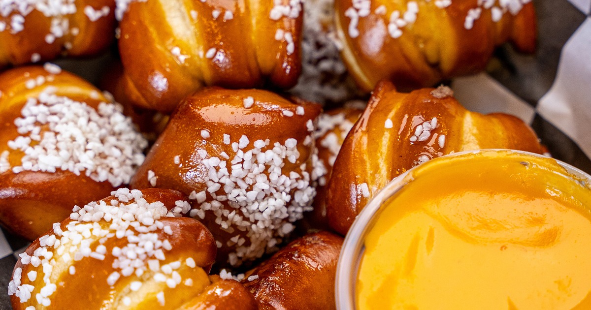 Soft pretzel bites served with dipping sauces, close-up