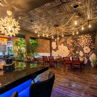 Interior featuring a floral wall mural, wooden flooring, and decorative chandeliers.