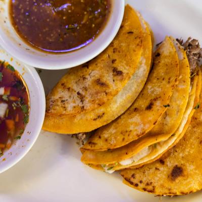 Quesabirria tacos and birria sauce.