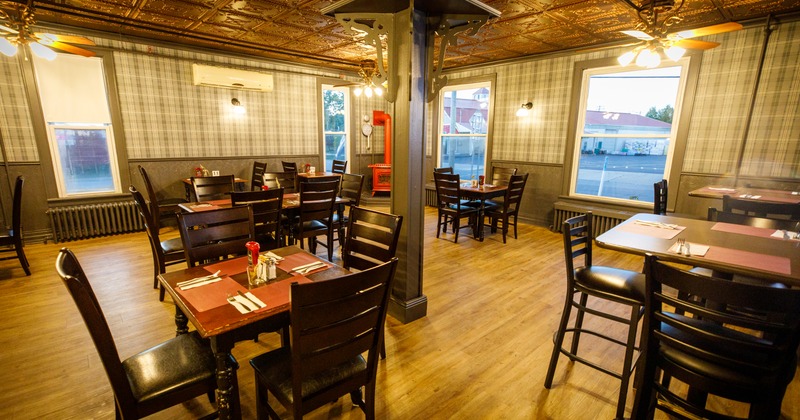 Interior with wooden tables and black wooden chairs.