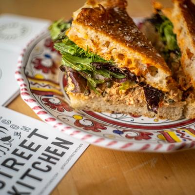 Aleppo tuna sandwich on a patterned plate.