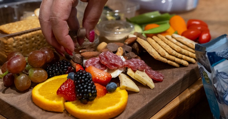 Charcuterie board food being arranged