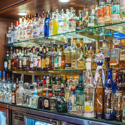 Back bar shelves with bottles of hard liquor.