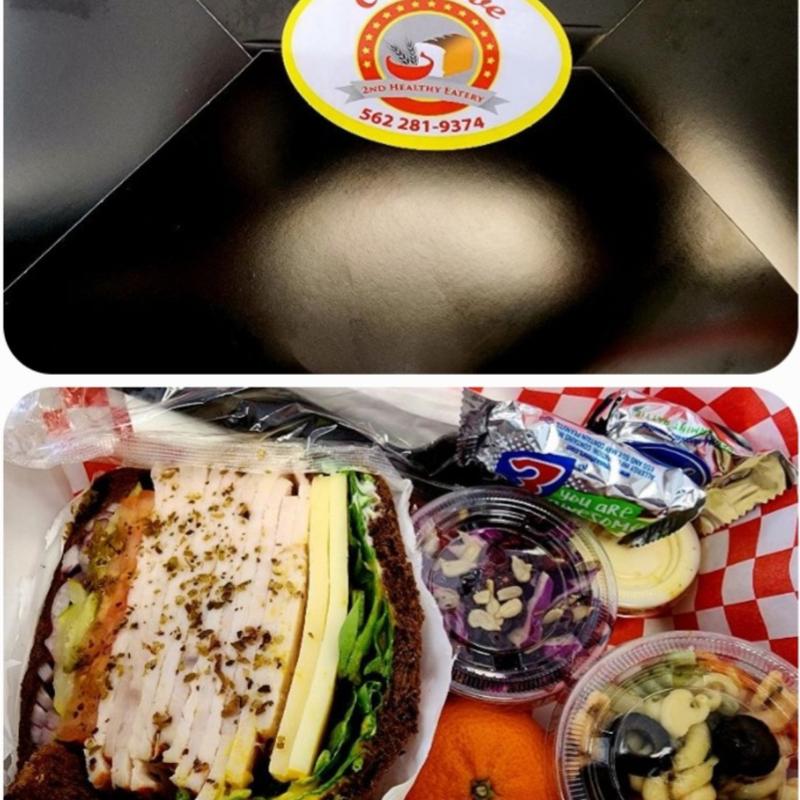 Catering Lunch Boxes - Comes with half Turkey Sandwich, Sliced Pickle, your choice of Pasta Salad or Coleslaw, Chips, and Fruit. photo