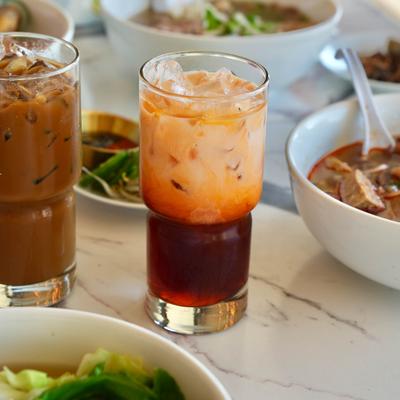 Vietnamese orange tea served alongside iced coffee.