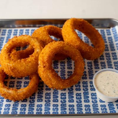 Crispy onion rings with dipping sauce.