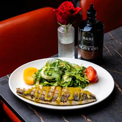 Grilled fish served with a side salad.