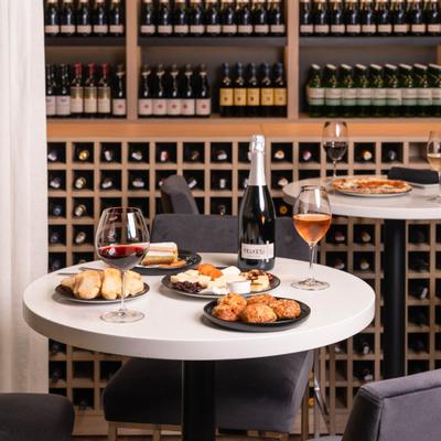 Wine bar table with sparkling wine and appetizers.
