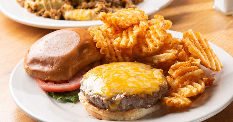 Burger with meat and cheese, snacks on the side