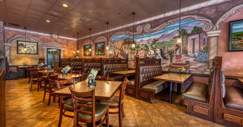 Interior seating area with chairs, tables and double booths