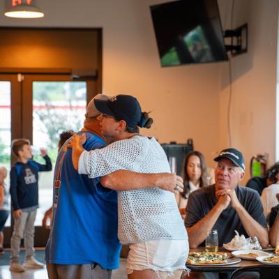 Two guests hugging.