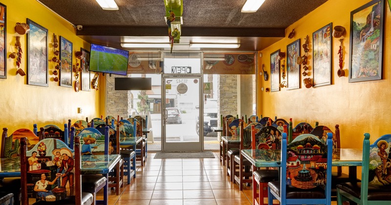 An interior seating area with an entrance located at the back