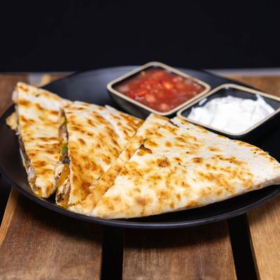 Chicken Quesadilla with salas and sour cream.