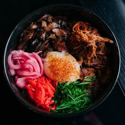 Rice bowl, with BBQ pork, pickled red onion, scallions, mushrooms, chili paste, and egg.