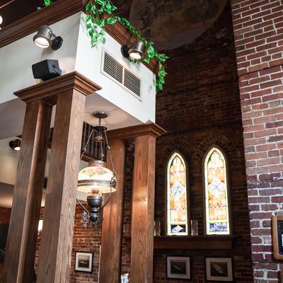 The interior of the restaurant, plants, windows.