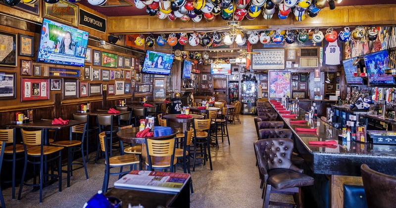 Interior, seating area and bar, helmet collection, walls decorated with pictures of sports players