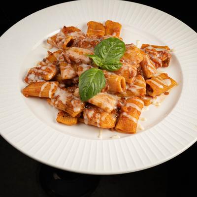 Rigatoni pasta, with spicy tomato sauce, bacon, basil, and pecorino.