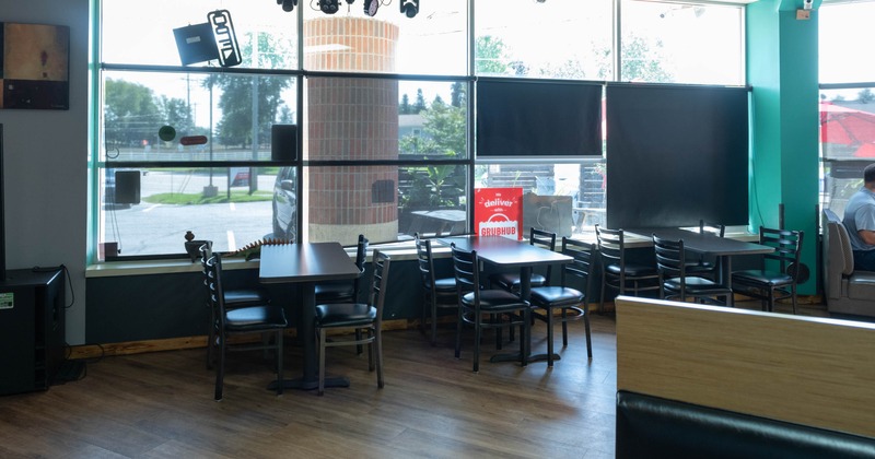 Interior, tables and chairs next to the window