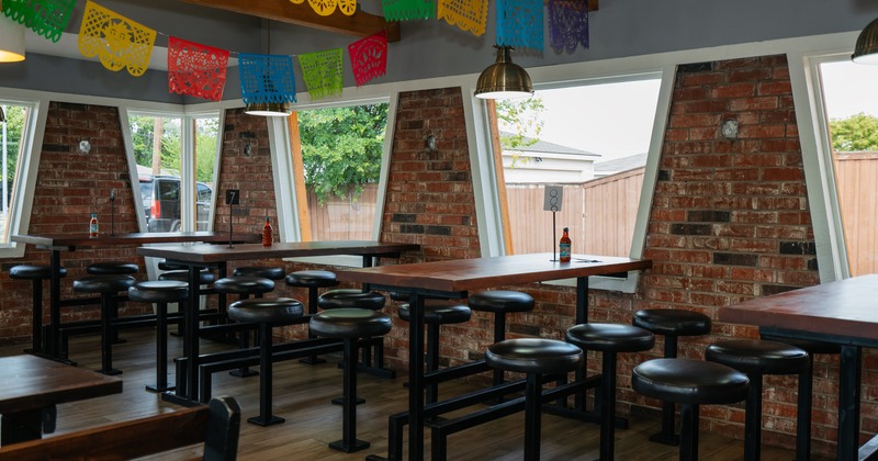 Interior, seating area with high tables and round stools