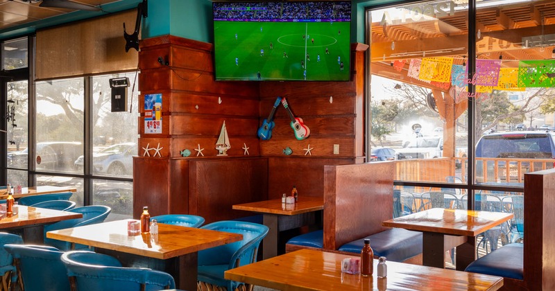 Interior, seating area near the windows with a TV on the wall