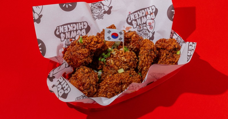 Korean fried chicken meal in paper-lined basket with a South Korean flag toothpick