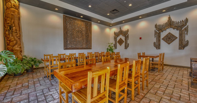 Interior, dining area, long table setups for sixteen, eight and four, tile flooring