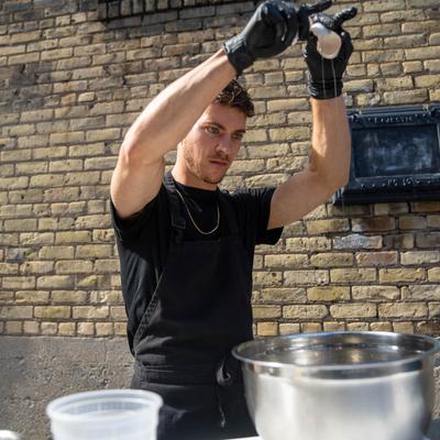 A person preparing food outdoors.