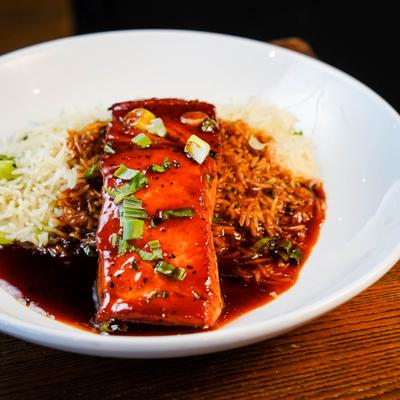 Salmon pan-seared with honey and gochujang glaze, served with basmati rice.