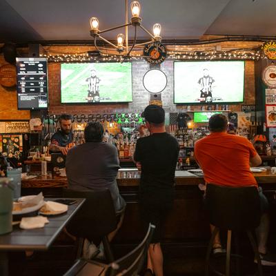 Customers sitting at the bar.