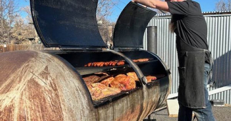 A person working on the smokeries outside