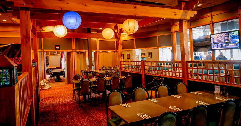 Interior of a restaurant with wooden beams, and neatly arranged tables