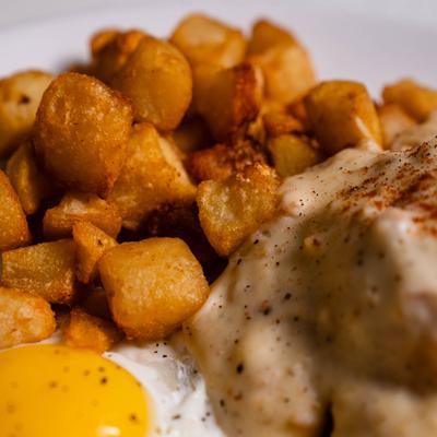 Biscuits and Gravy, with fried eggs, and breakfast potatoes.
