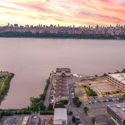 Waterfront venue and city skyline at sunset.