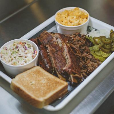 Three meat combo platter, served with two sides and a toast, top view.