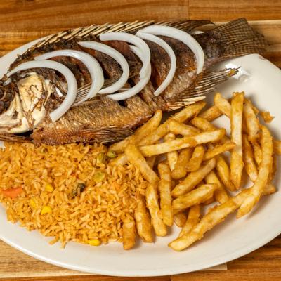 Fried whole fish, with onions, rice, and fries.