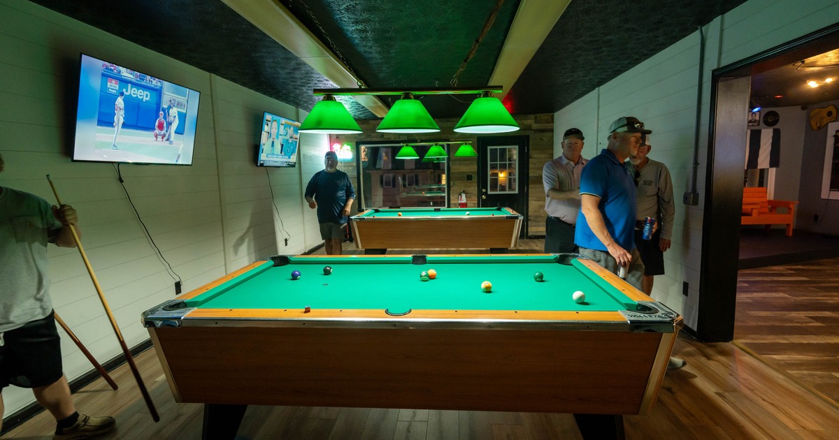 People playing pool in a billiards room
