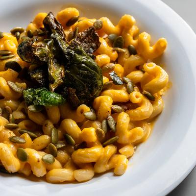 Sweet potato Mac n Cheese topped with greens.