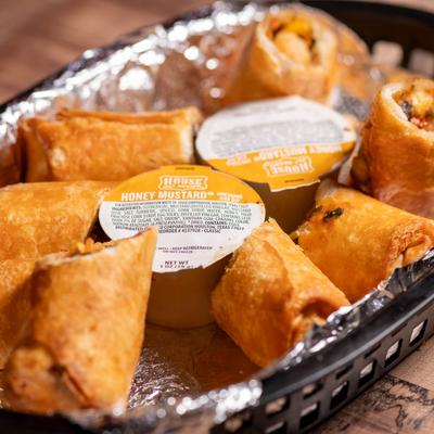 Egg rolls served with honey mustard.