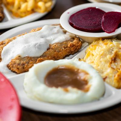 Southern chicken fried steak with pickled beets, mashed potatoes, and macaroni and cheese.
