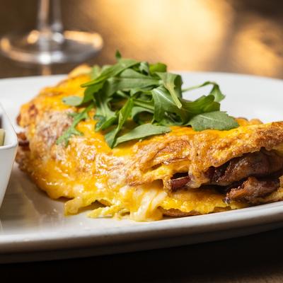 Bacon, Avocado, and Jack Omelet served with fresh fruit cup.