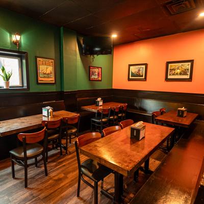 Dining area with wooden tables, colorful walls, and wall art.