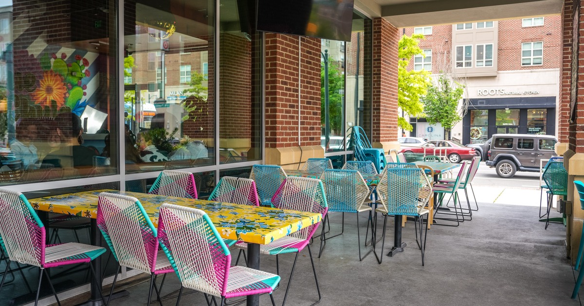 Exterior, front patio with colorful tables and chairs