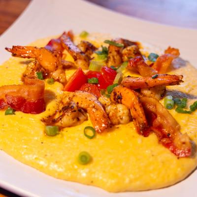 Shrimp and grits, served on a plate, closeup.