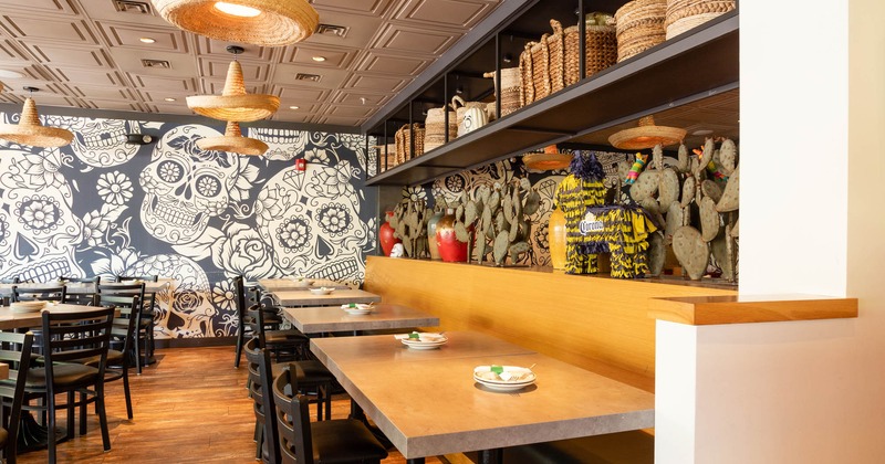 Interior, dining tables, wall mural with Mexican skull motifs, decorations