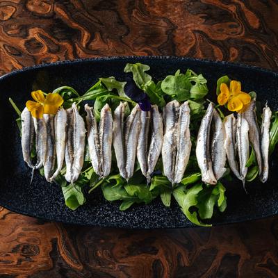 Marinated Anchovies on the bed of arugula.