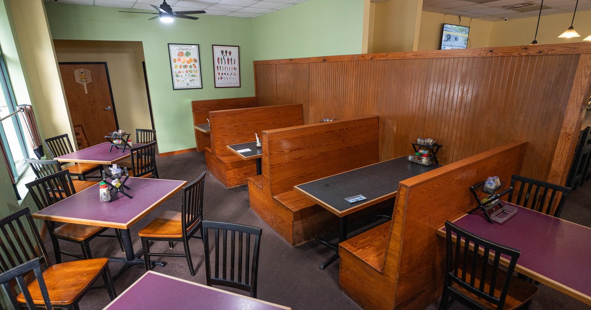 A cozy restaurant interior with wooden booths and tables