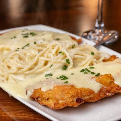 Lemon chicken Romano, served, front view, closeup.