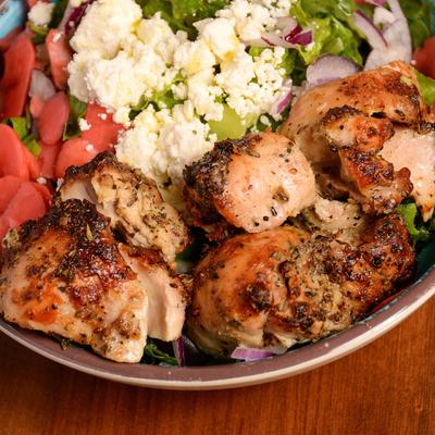 Roasted chicken with vegetables and cheese in a bowl